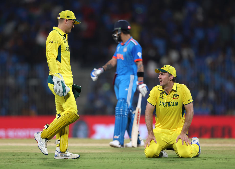 Alex Carey looks at Mitch Marsh.