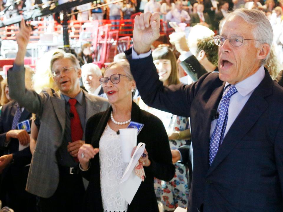 Jim, Alice, and Rob Walton cheer during Walmart shareholder meeting