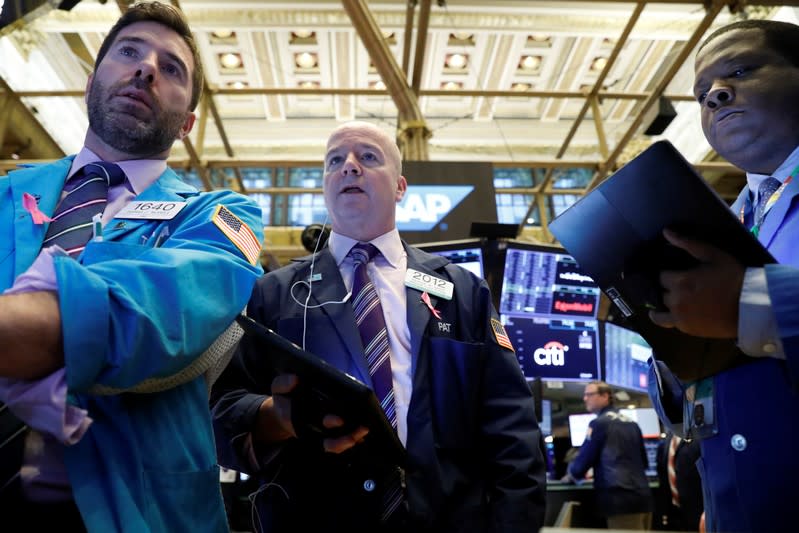 Traders work on the floor at the NYSE in New York