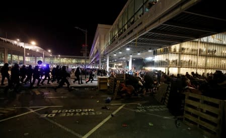 Protesters form barricades as they demonstrate at the airport, after a verdict in a trial over a banned independence referendum, in Barcelona