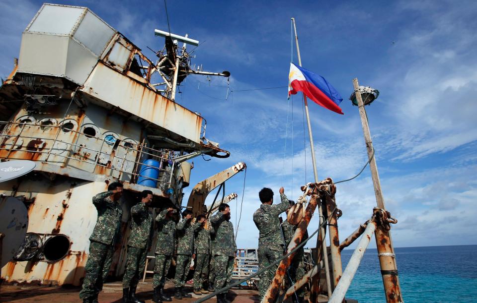 Troops stationed aboard the Sierra Madre, take part in a flag retreat, March 29, 2014.