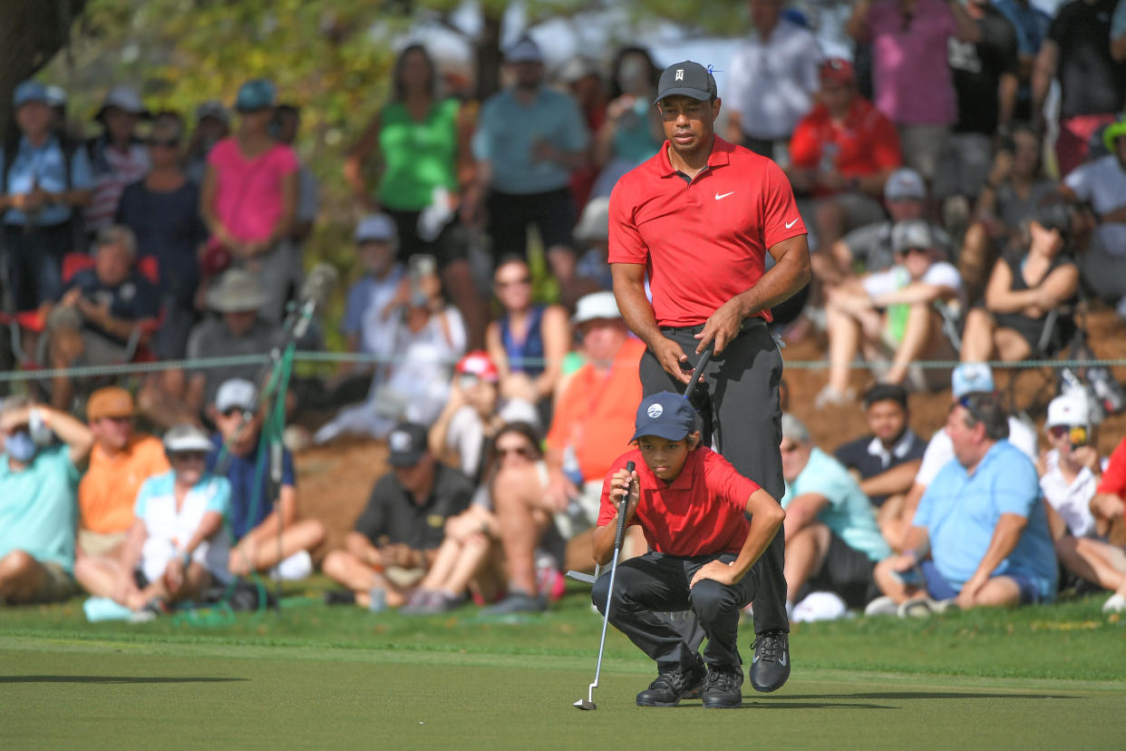 ORLANDO, FL - DECEMBER 19: Tiger Woods and his son, Charlie Woods, read the ninth green during the final round of the PGA TOUR Champions PNC Championship at Ritz-Carlton Golf Club on December 19, 2021 in Orlando, Florida. (Photo by Ben Jared/PGA TOUR via Getty Images)