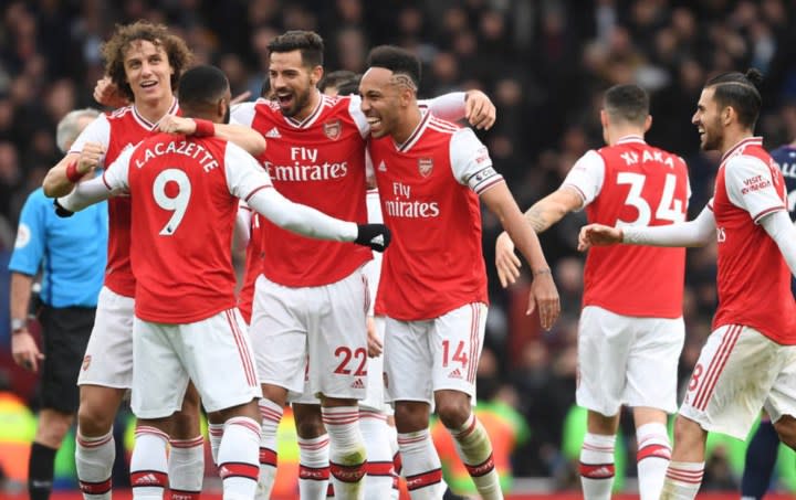 Arsenal FC players celebrating on the field.