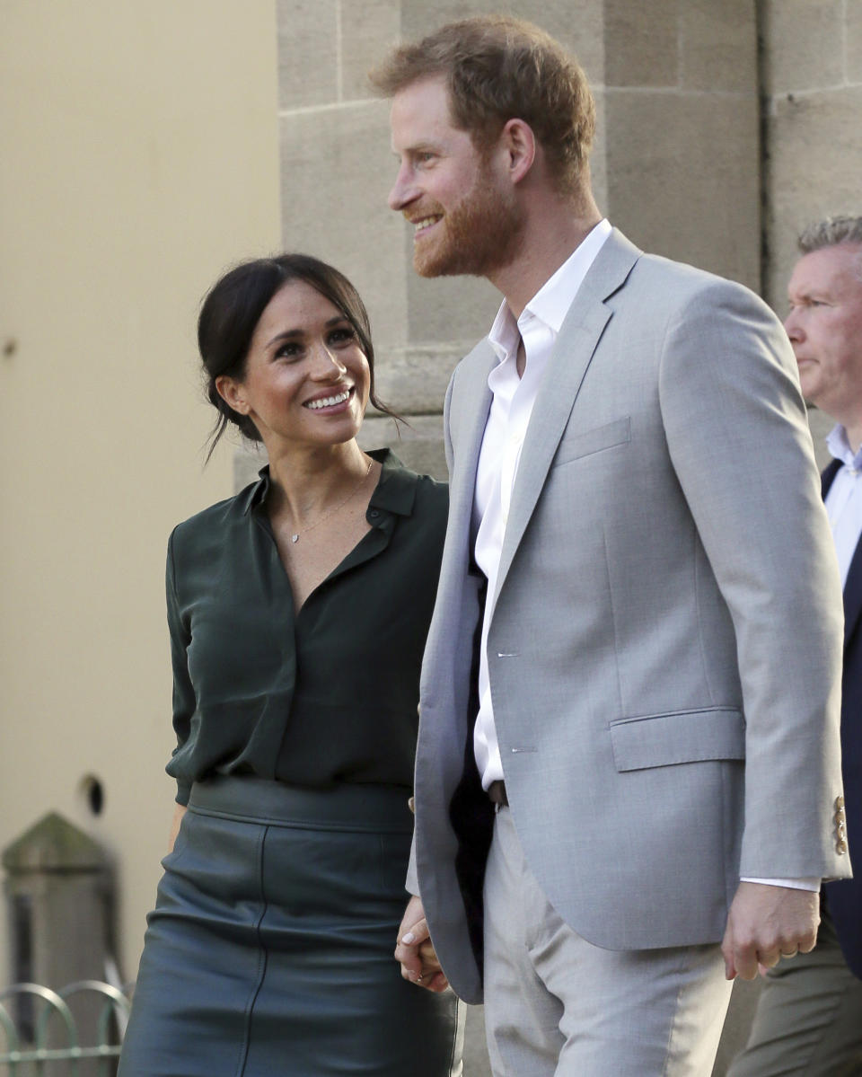 FILE - In this file photo dated Wednesday, Oct. 3, 2018, Britain's Prince Harry, right, and Meghan, Duchess of Sussex visit the Pavilion Building in Brighton, England. Kensington Palace announced Monday Oct. 15, 2018, that Prince Harry and his wife the Duchess of Sussex are expecting a child in spring 2019. (AP Photo/Tim Ireland, FILE)