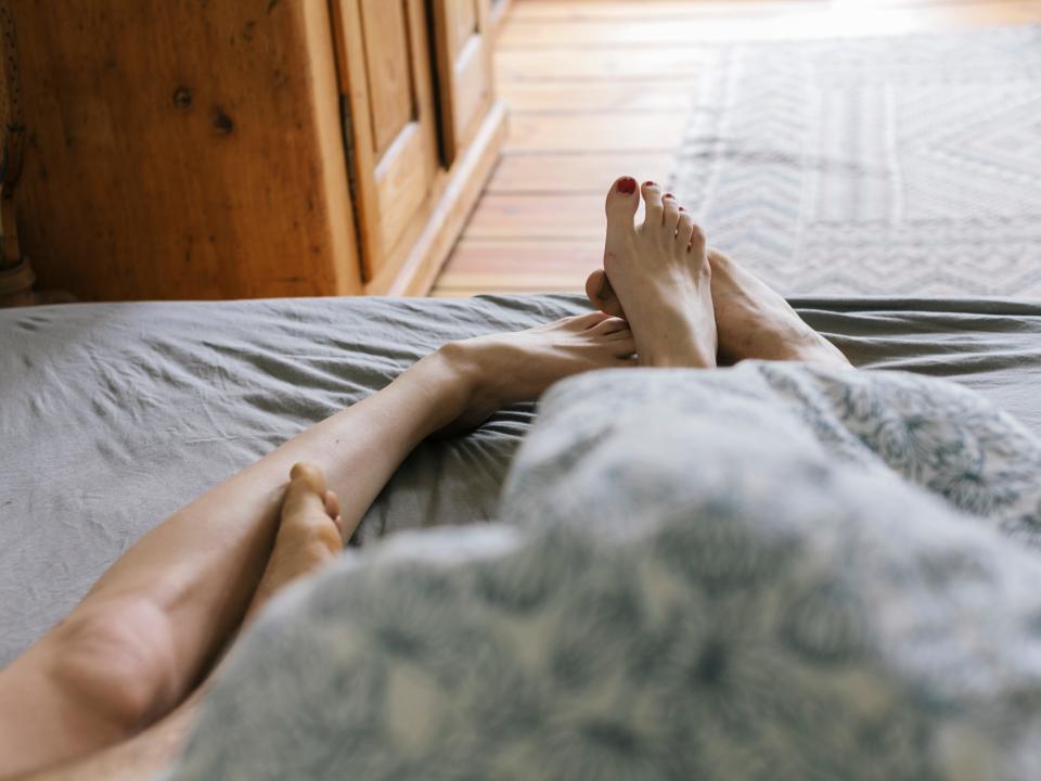 Couple's feet in bed