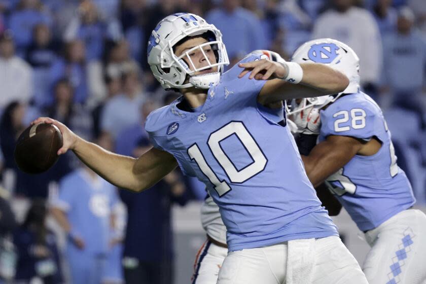 North Carolina quarterback Drake Maye (10) crosses back to pass during the first half.