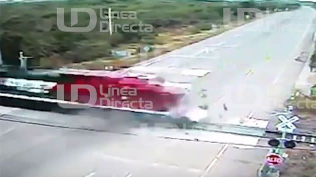 Debris can be seen flying everywhere after the bus ran over the crossing which has no warning lights of barriers. Photo: Supplied