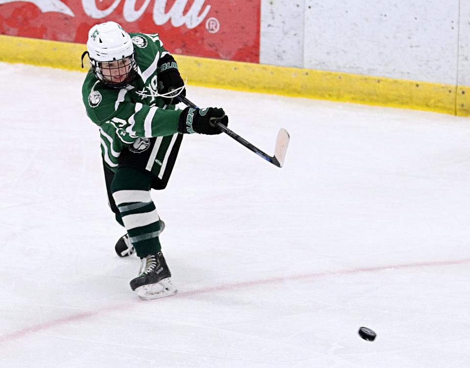 Canton's Devan Spinale fires a shot during the Final Four game against Natick in the Division 2 state tournament at Gallo Ice Arena on Monday, March 14, 2022.