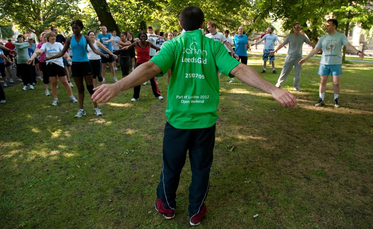 Participants stretch ahead of the 5km parkrun around Hyde Park in Leeds (PA Archive)