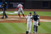 New York Yankees catcher Gary Sanchez, right, talks to Jonathan Loaisiga during the eighth inning of a baseball game as Washington Nationals' Josh Harrison (5) waits near the plate, Friday, May 7, 2021, in New York. (AP Photo/Frank Franklin II)