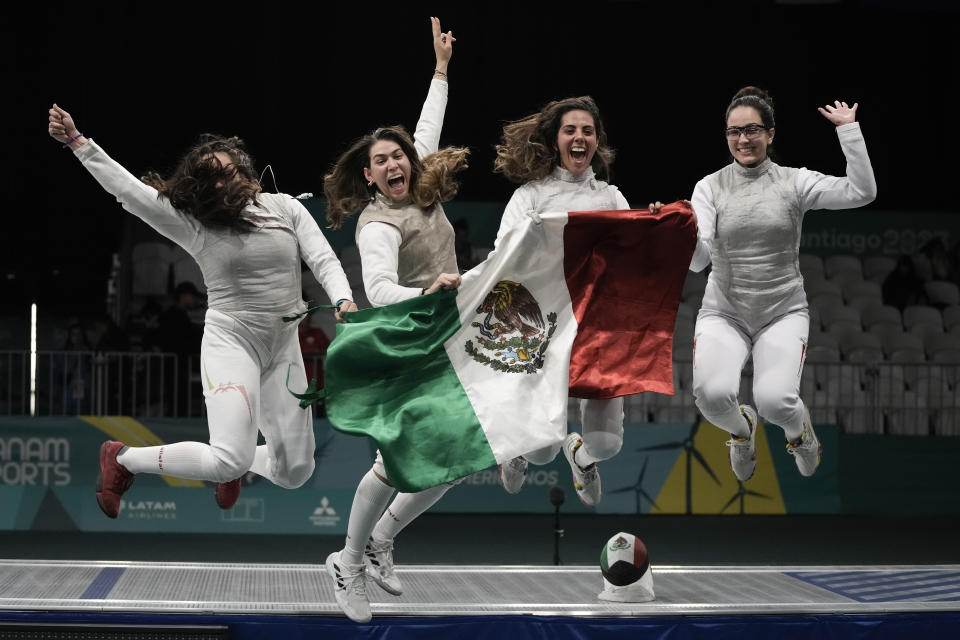 Members of the Mexican women's fencing foil team celebrate their bronze medal victory, at the Pan American Games in Santiago, Chile, Thursday, Nov. 2, 2023. (AP Photo/Eduardo Verdugo)