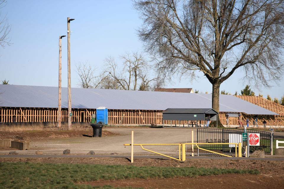 Construction takes place on the site of four large poultry houses at a Foster Farms facility in Aurora.