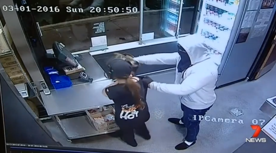 The offender forces a young woman to open the till.