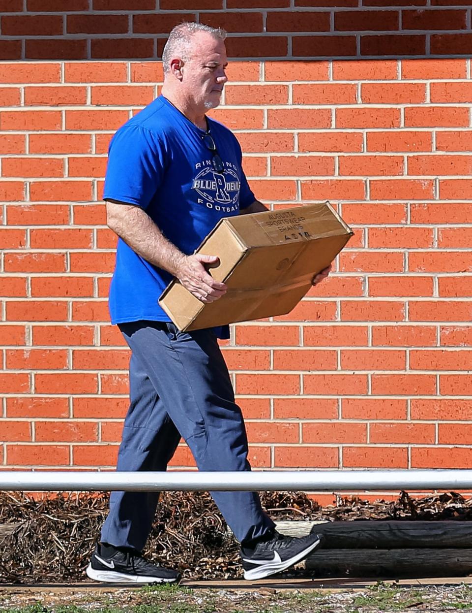 Philip Koons, the Ringling High School football coach and principal, walks out of the Ringling Public Schools superintendent's office on Feb. 22, 2023, when he was placed on leave amid allegations that he bullied players.