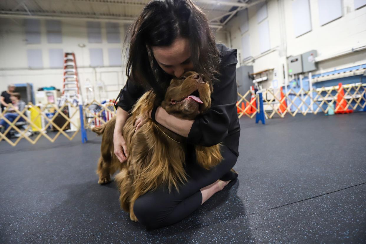 Samantha Gibson, 43, of Ferndale, gives Clyde, her Sussex spaniel, kisses toward the end of practice at Sportsmen's Dog Training Club of Detroit in Warren on Monday, April 29, 2024. Gibson says her love for Clyde is why she competes and wants to make it fun for them.