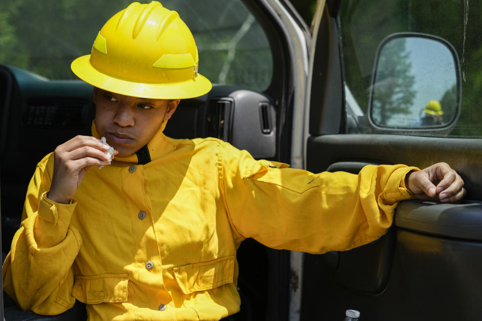 Taylor Mohead rests after a wildland firefighter training Friday, June 9, 2023, in Hazel Green, Ala. A partnership between the U.S. Forest Service and four historically Black colleges and universities is opening the eyes of students of color who had never pictured themselves as fighting forest fires. (AP Photo/George Walker IV)