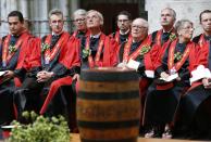 Members of the Knighthood of the Brewers' Mash staff attend a mass in front of a barrel of beer at the Sint-Gudule Cathedral in Brussels, during celebrations of Saint-Arnould, patron saint of brewers, September 6, 2013. REUTERS/Francois Lenoir(BELGIUM - Tags: SOCIETY RELIGION)