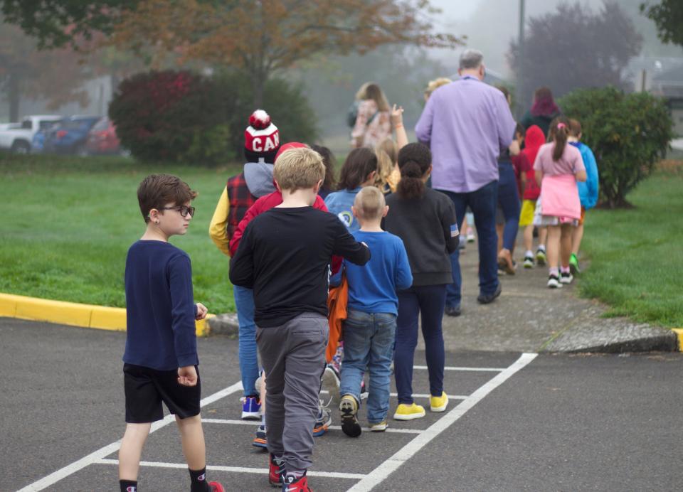 Students at McCornack Elementary School evacuate their classrooms after an earthquake drill for the Great Oregon ShakeOut on Oct. 19 in Eugene.