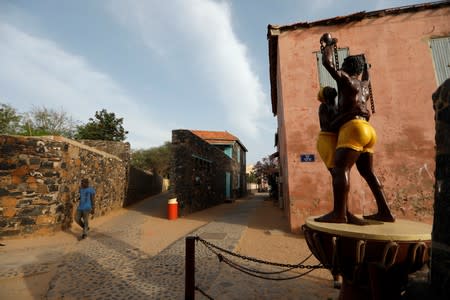 Resident walks beside a statue commenorating slavery's abolition near the 'Maison Des Esclaves' slaves' house at Goree Island off the coast of Dakar