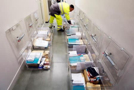 A municipal employee prepares ballot boxes on the eve of the first round of the French presidential election at a polling station in Tulle, France, April 22, 2017. REUTERS/Regis Duvignau