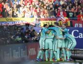 Football Soccer - Atletico Madrid v Barcelona - Spanish La Liga Santander - Vicente Calderon Stadium, Madrid, Spain, 26/02/17 Barcelona's Lionel Messi (hidden) is mobbed by celebrating team mates after scoring a goal. REUTERS/Susana Vera