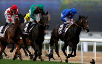 Horse Racing - Dubai World Cup - Meydan Racecourse, Dubai - 25/3/17 - Christophe Soumillon rides Vazirabad to the finish line to win the third race. REUTERS/Ahmed Jadallah