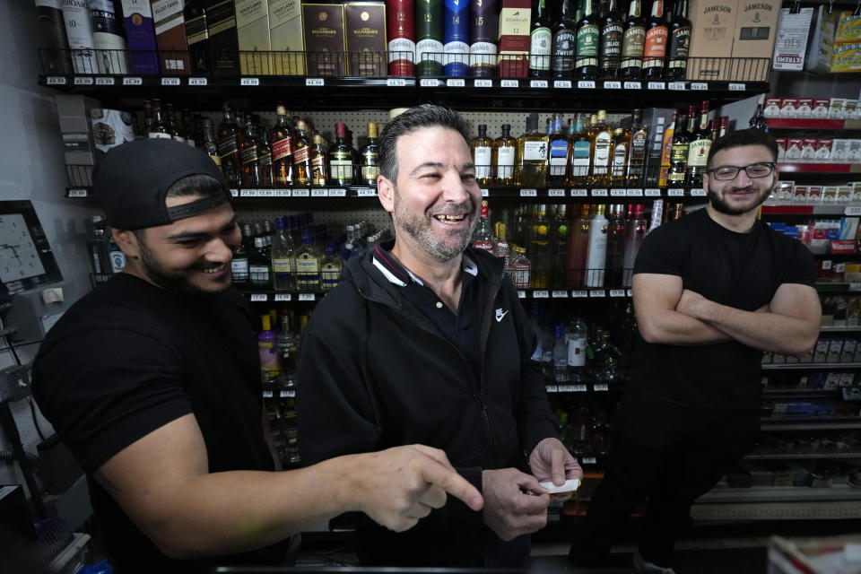 Store co-owner Nidal Khalil, center, goes over the previous day's lottery ticket sales with nephew Chris Khalil, left, and son Jonathan Khalil, right, at the Midway Market & Liquor store, Thursday, Oct. 12, 2023, in Frazier Park, Calif., where a winning Powerball lottery ticket was sold. A player in California won a $1.765 billion Powerball jackpot Wednesday night, ending a long stretch without a winner of the top prize. (AP Photo/Marcio Jose Sanchez)