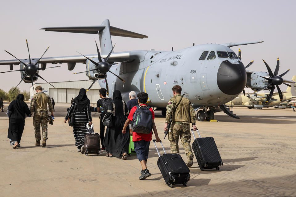 In this handout image provided by the UK Ministry of Defence, on Thursday, April 27, 2023, British Nationals board an RAF aircraft for evacuation of civilians to Larnaca International Airport in Cyprus, at Wadi Seidna military airport, 22 kilometres (14 mi) north of Khartoum, Sudan. The UK government assisted by the British Military has evacuated British Citizens from Sudan. RAF flights are continuing between Wadi Seidna airport in Sudan to Larnaca International Airport, following three evacuation flights that took place late overnight between Tuesday 25 April and Wednesday 26 April. (PO Phot Aaron Hoare/UK Ministry of Defence via AP)