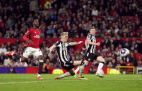 Newcastle United's Anthony Gordon scores their side's first goal of the game during the English Premier League soccer match between Manchester United and Newcastle United, in Manchester, England, Wednesday, May 15, 2024. (Martin Rickett/PA via AP)
