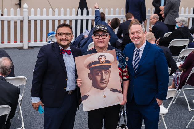 Vice chair of the California Democratic Party Davis Campos (left), LGBTQ activist Nicole Murray-Ramirez (center) and Bevan Dufty, director of the San Francisco Bay area rapid transit district, pose with a photo of Harvey before the launch of the USNS Harvey Milk in San Diego on Saturday. (Photo: ARIANA DREHSLER via Getty Images)