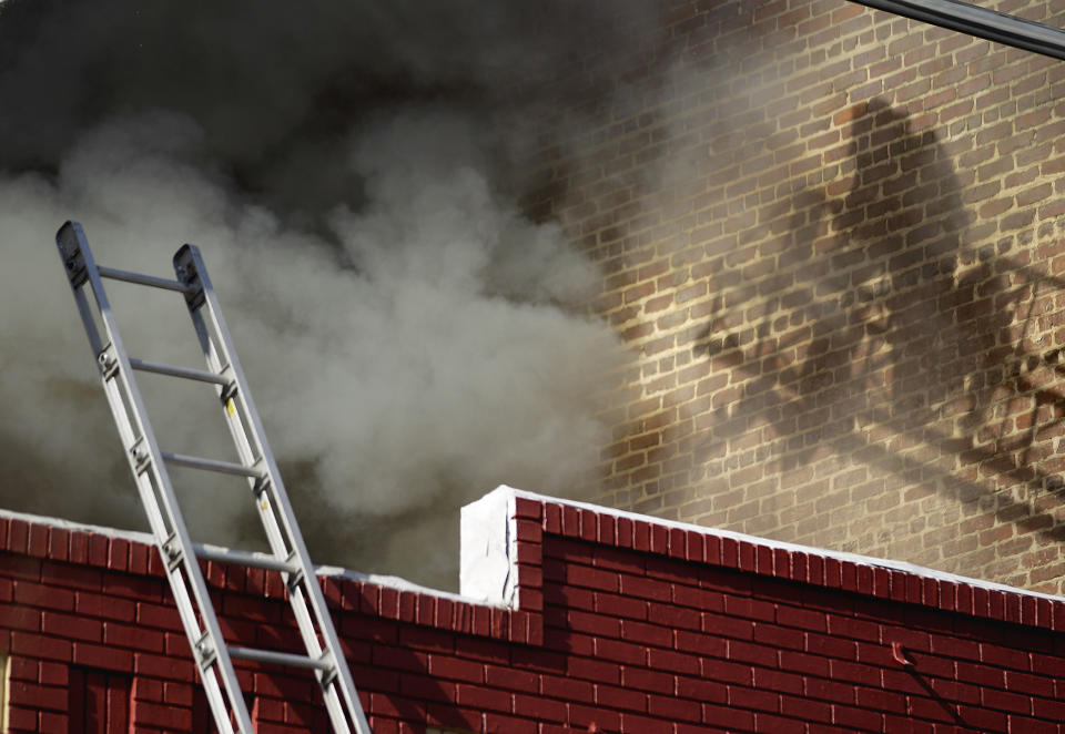 <p>A firefighter battles a blaze from a ladder that shot thick, black smoke into the sky over the downtown area, March 15, 2012, in Atlanta. Atlanta Fire Capt. Jolyon Bundridge said a restaurant was on fire. Bundridge was not aware of any injuries in the Thursday morning fire. (AP Photo/David Goldman) </p>