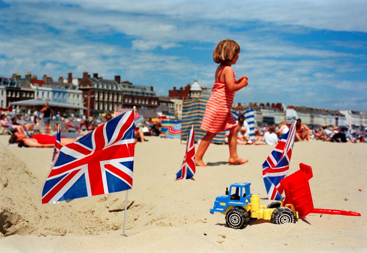 <span>A girl plays on the beach at Weymouth in 1998, as shot by Martin Parr.</span><span>Photograph: Martin Parr/Magnum Photos</span>