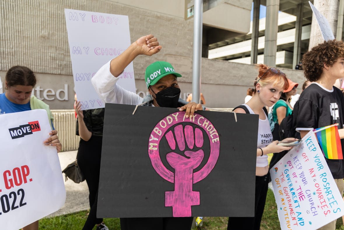 An abortion rights activist holds a sign at a protest in support of abortion access, March To Roe The Vote And Send A Message To Florida Politicians That Abortion Access Must Be Protected And Defended, on July 13, 2022 in Fort Lauderdale, Florida. (Photo by John Parra/Getty Images for MoveOn)
