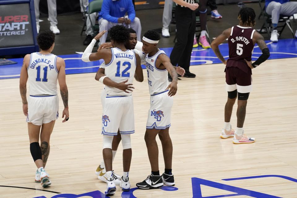 Memphis' Lester Quinones (11), DeAndre Williams (12), D.J. Jeffries, rear, and Landers Nolley II, right, celebrate in the closing seconds of their NCAA college basketball championship game in the NIT as Mississippi State guard Deivon Smith (5) stands nearby, Sunday, March 28, 2021, in Frisco, Texas. (AP Photo/Tony Gutierrez)