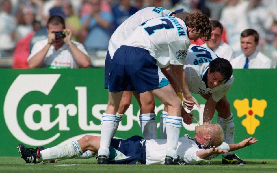 England goalscorer Paul Gascoigne celebrates in the 'Dentists Chair' with Steve McManaman (l) Alan Shearer (obscured) and Jamie Redknapp during the 1996 European Championships group stage match against Scotland at Wembley Stadium on June 15, 1996 in London, England. (Photo by Stu Forster/Allsport/Getty Images)