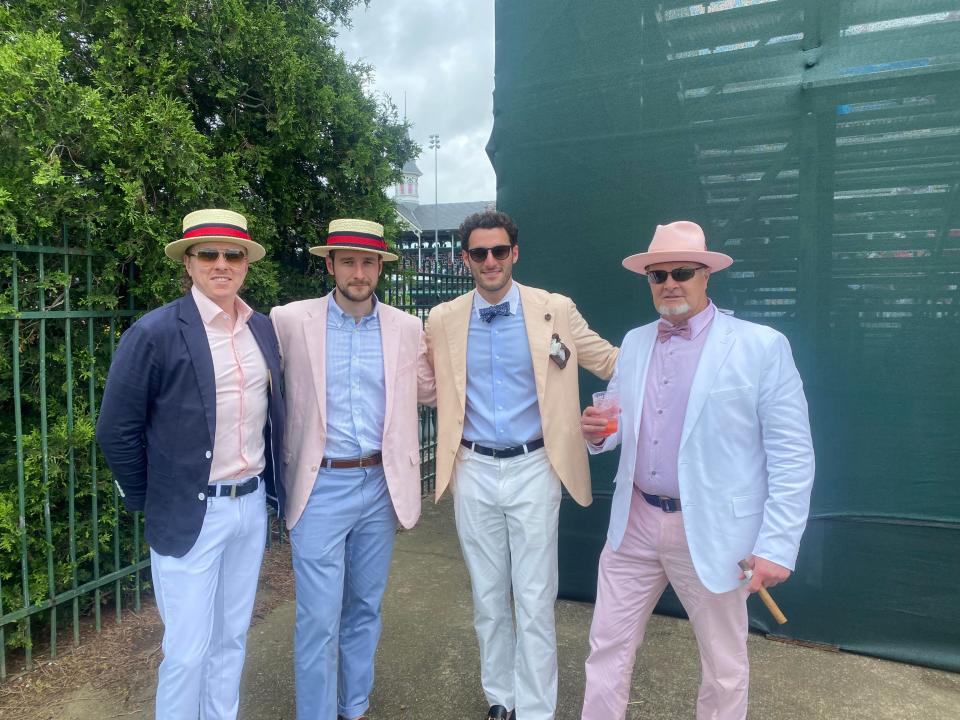 Mike Regan of Andover, Mass., right, with sons Nicholas (second from right) and Daniel (third from right) and nephew Eric (left) at the Infield Reserve Bleachers on Oaks Day. (Josh Wood / Courier Journal)