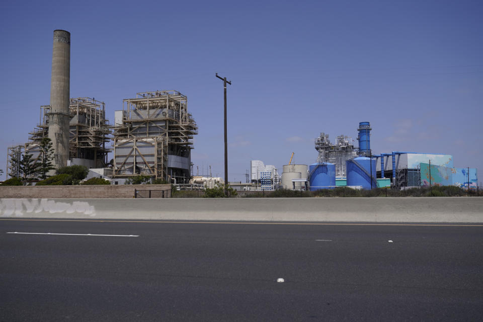 This May 2, 2022, photo shows the AES Huntington Beach Energy Center in Huntington Beach, Calif. The AES facility, the proposed site of the Poseidon Huntington Beach Seawater Desalination Plant will face a critical vote by the California Coastal Commission (CCC) on Thursday, May 12. The highly contested project has been debated for more than two decades. The commission's staff issued a scathing report recommending the agency reject the project due to concerns about the impact on marine life, the cost to ratepayers, and the impact of sea-level rise on the low-lying area where it would be built. Business and labor groups argue it will provide another source of much-needed water. (AP Photo/Damian Dovarganes)