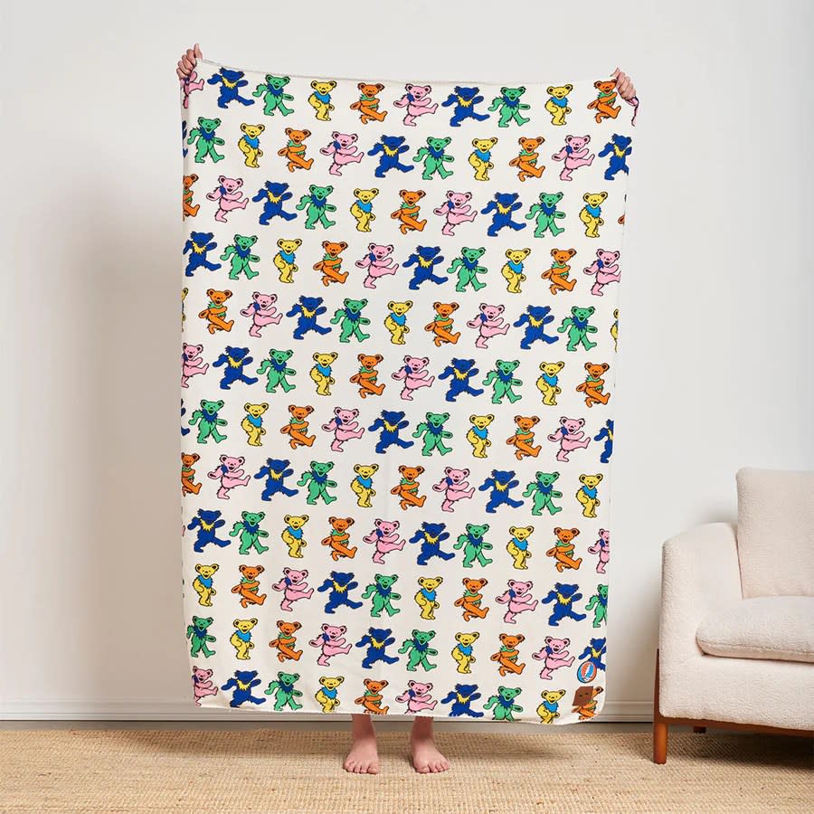 cream blanket with multi-colored bear pattern
