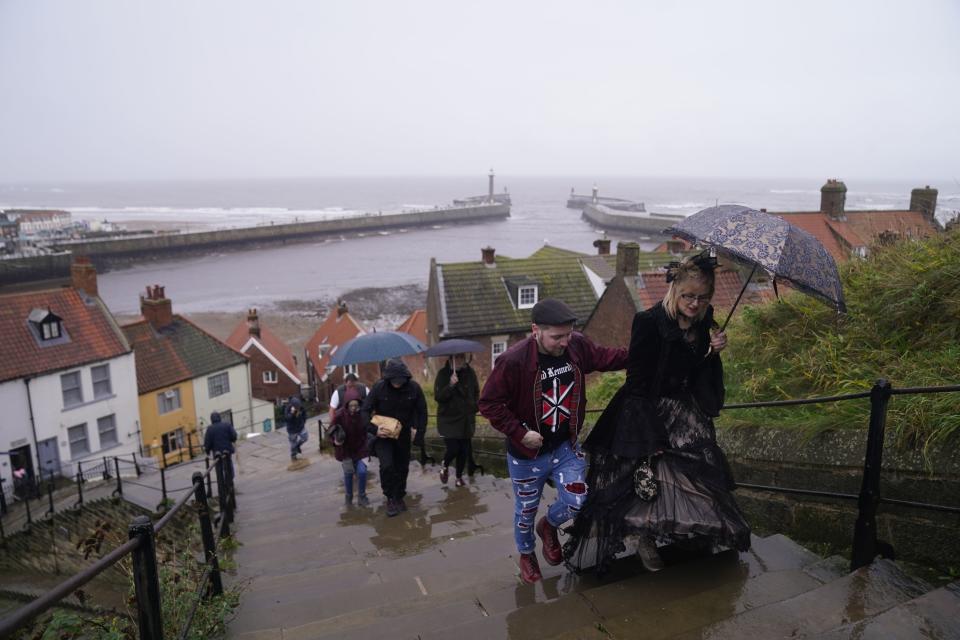 People braving the rain as they attend the Whitby Goth Weekend in Whitby, Yorkshire. (PA)