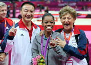<p>Douglas celebrates winning the gold medal with coach Liang Chow and team coordinator Martha Karolyi after the individual all-around final. (Streeter Lecka/Getty Images) </p>