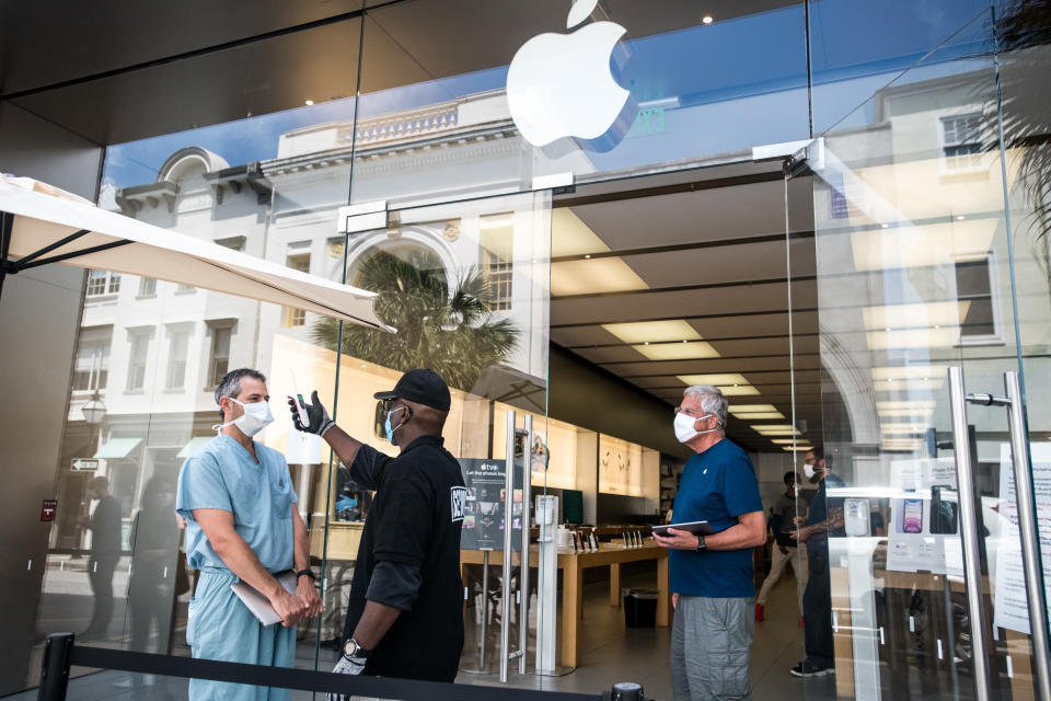 CHARLESTON, SC - MAY 13: A security guard takes the temperature of a customer outside the Apple Store on May 13, 2020 in Charleston, South Carolina. Customers had their temperatures taken and were required to wear masks at the South Carolina store, as locations in Idaho, Alabama, and Alaska reopened as well following forced closures due to the coronavirus. (Photo by Sean Rayford/Getty Images)