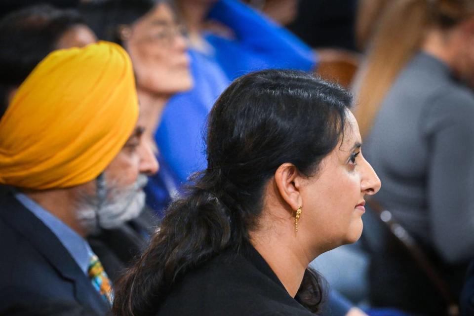 Assemblywoman Jasmeet Bains, D-Delano, sits at her desk with family on Dec. 5, 2022, during the Assembly organizational session at the state Capitol. Bains said she was removed from the Assembly Business and Professions Committee after she voted against a bill to hold oil companies accountable for high gas prices.