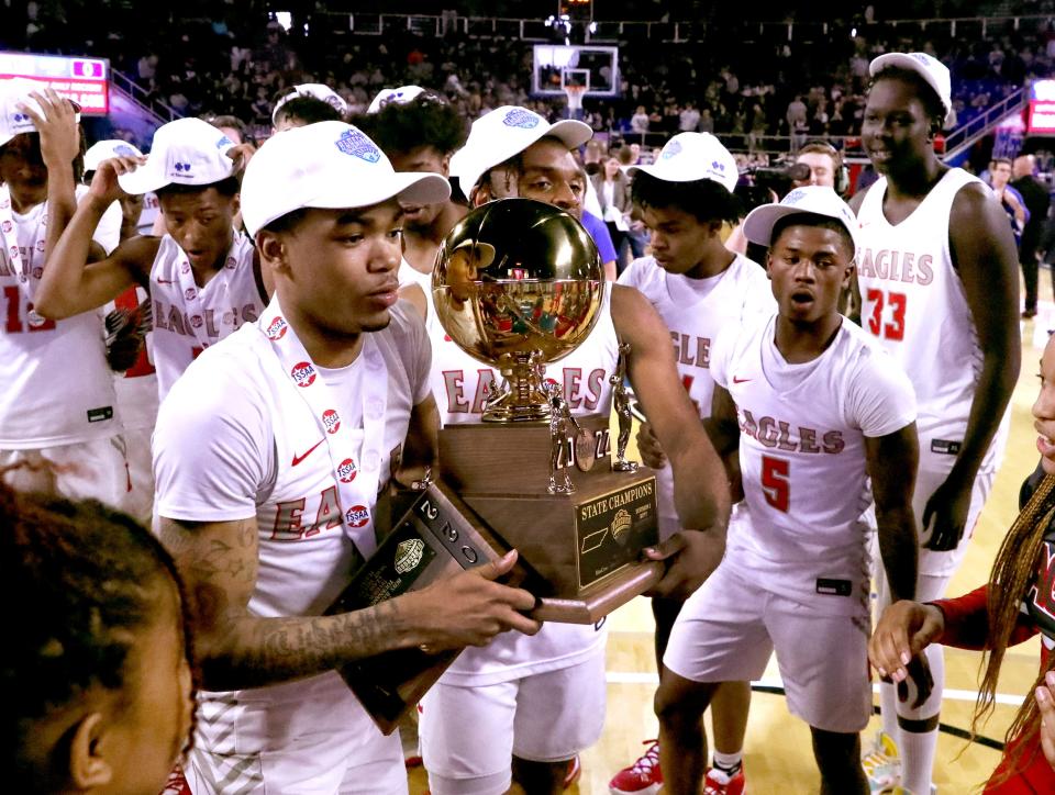 East Nashville's Jaylen Jones (1) and East Nashville's Jarrod Taylor (0) take the the Class 2A TSSAA BlueCross Boys Basketball State Championship trophy and present it to East Nashville's boys head coach Avery Patton after beating Milan in the 2022 Class 2A TSSAA BlueCross Boys Basketball State Championship, on Saturday, March 19, 2022, at Murphy Center in Murfreesboro, Tenn.  