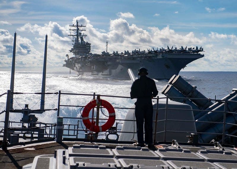 Seaman Marcus White, from San Diego, stands watch as aft lookout aboard the Ticonderoga-class guided-missile cruiser USS Chancellorsville (CG 62) during a replenishment-at-sea with the Nimitz-class aircraft carrier USS Ronald Reagan (CVN 76)