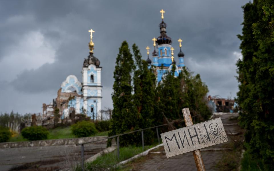 A sign warning of mines stands in front of the war-damaged Orthodox Church of the Holy Mother and convent, in a Donbas village that was fought over and largely destroyed, then occupied by invading Russian forces from June to September 2022, in the village of Bohorodychne, Ukraine - Scott Peterson/Getty Images Europe