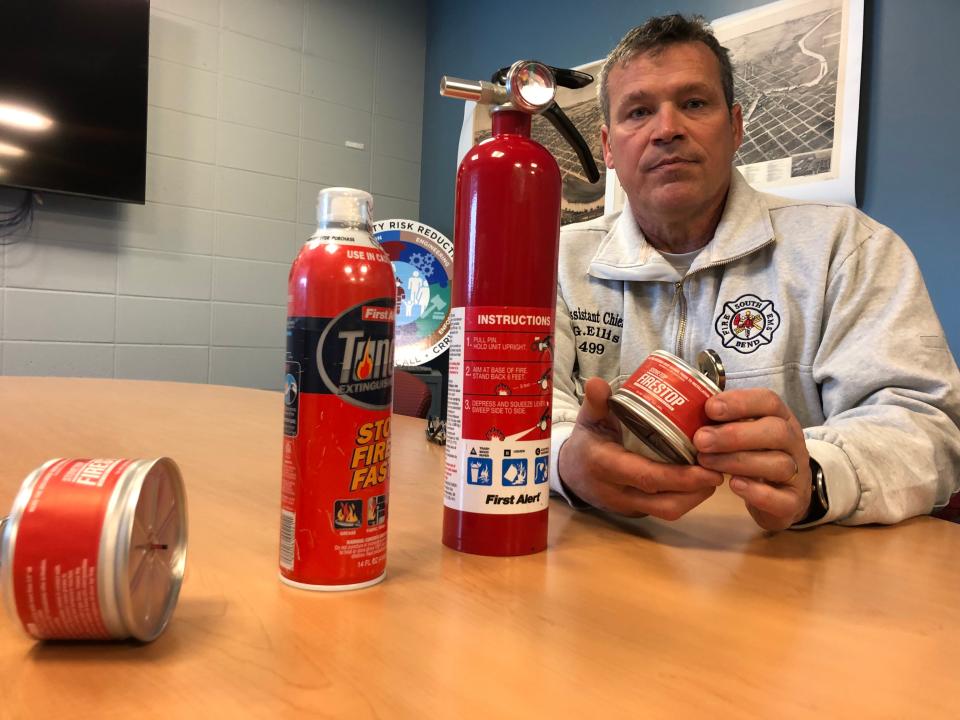 Gerard Ellis, assistant chief of prevention for the South Bend Fire Department, shows off different kinds of home fire extinguishers on Wednesday, Jan. 24, 2024. From left: a FireStop can that goes above the stove, a small Tundra extinguisher that's good for kitchen fires and a standard extinguisher.
