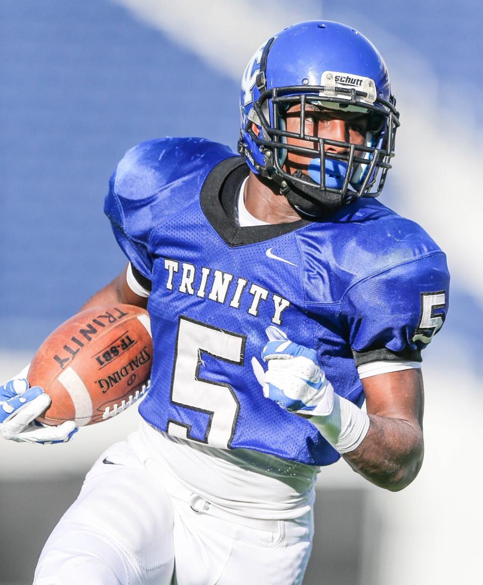 In this 2014 file photo, Trinity Christian's Chris Barr runs the ball against American Heritage during high school Class 3A State Final football action at the Florida Citrus Bowl in Orlando. Trinity won 27-7. Barr went on to play for the University of South Florida and work for the Jacksonville Sheriff's Office before being arrested on Jan. 27 and resigning.