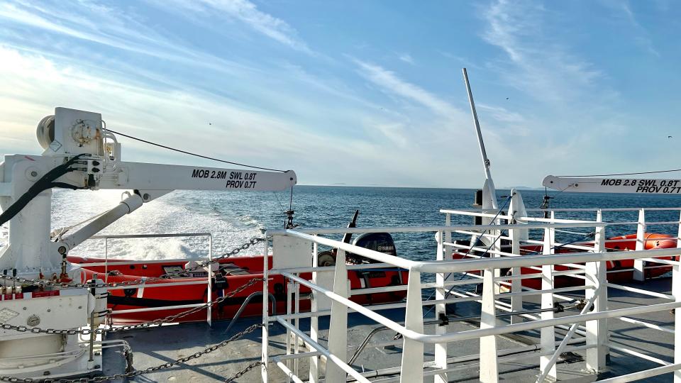 Deck on the victoria ferry with view of lifeboats and water