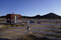 A "No Trespassing sign" hangs at the entrance to the Bonanza Creek Film Ranch in Santa Fe, N.M., Saturday, Oct. 23, 2021. An assistant director unwittingly handed actor Alec Baldwin a loaded weapon and told him it was safe to use in the moments before the actor fatally shot a cinematographer, court records released Friday show. (AP Photo/Jae C. Hong)