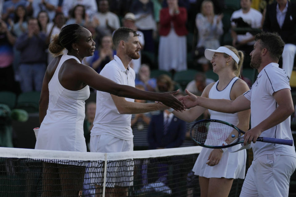 CAPTION CORRECTS THE RESULTS OF THE MATCH Venus Williams of the U.S., left, and Britain's Jamie Murray shake hands after losing the second round mixed doubles match against Britain's Jonny O'Mara and Alicia Barnett on day seven of the Wimbledon tennis championships in London, Sunday July 3, 2022. (AP Photo/Alastair Grant)